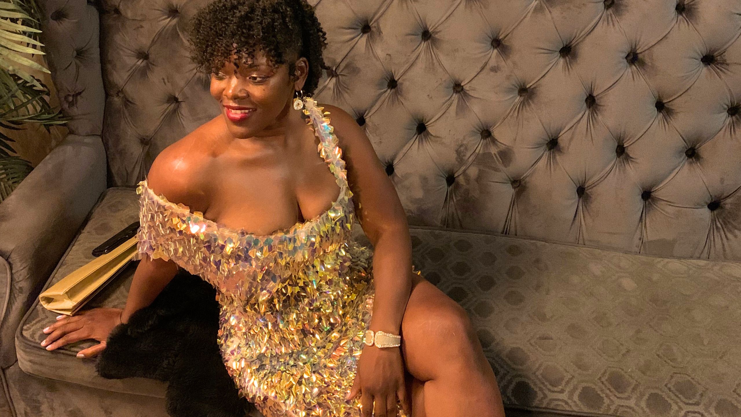 Sheridonna in a Custom Sheridonna Designs Sequence dress sitting on a luxurious lounge couch looking stunning and powerful a a movie premier in Washington DC