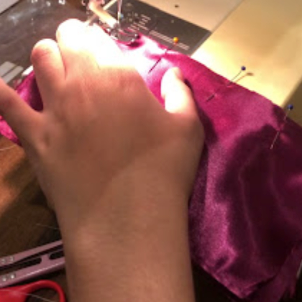Student leaning how to sew with Sheridonna at UFI