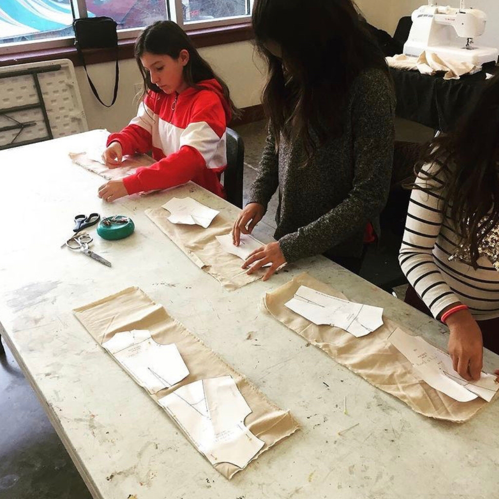 Student leaning how to cut out patterns at UFI