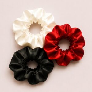 Flat lay of satin scrunchie set red white and black luxury hair accessories